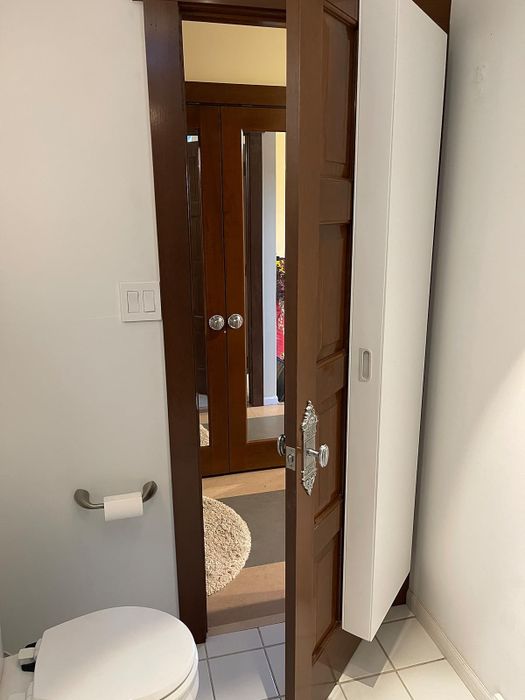 Reviewer’s bathroom door with a white storage cabinet attached