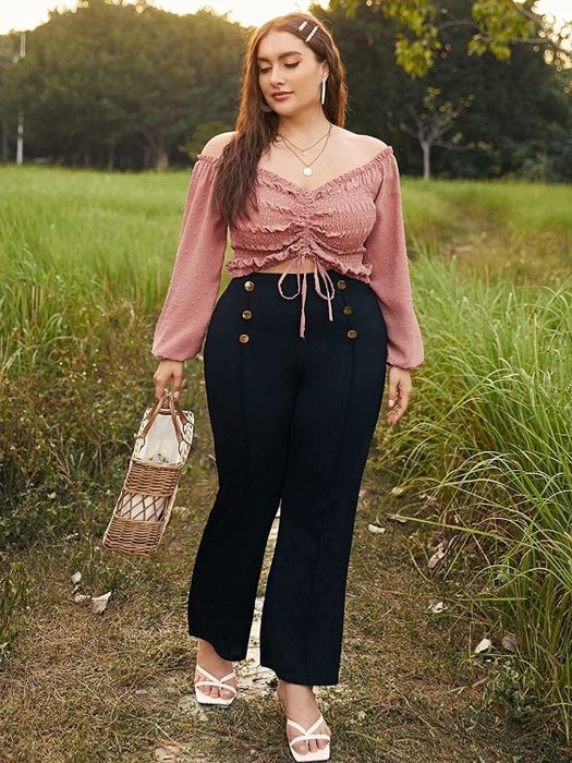 A model wearing a soft blush-colored top.