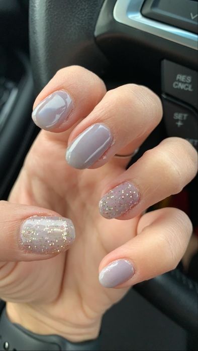 A reviewer with periwinkle nails and a glittery white accent nail on the thumb.