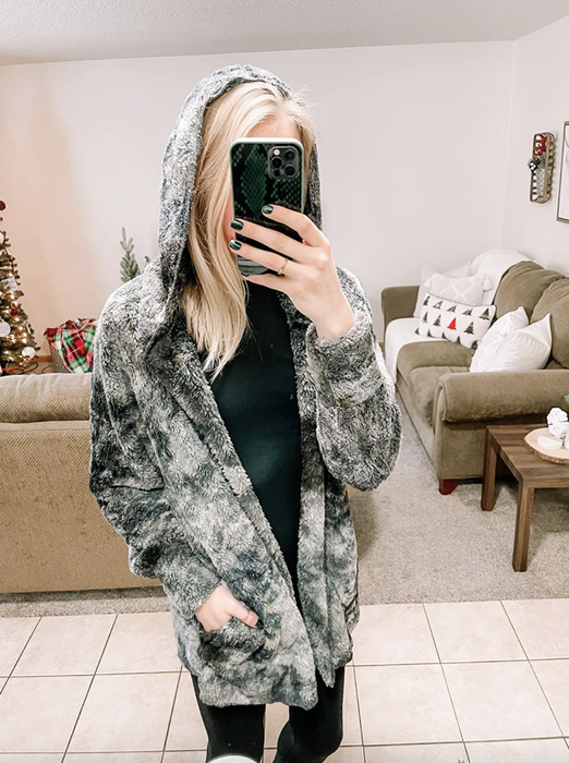 A reviewer modeling the tie-dye cardigan.
