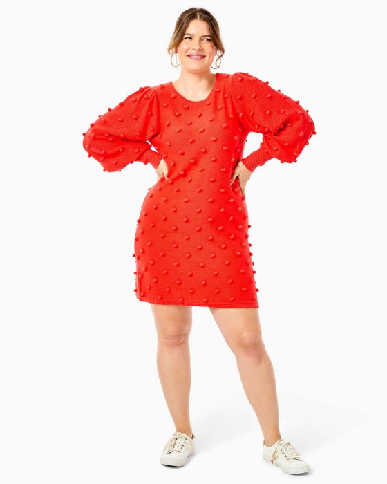 A model rocking the ruby red polka dot pom dress.