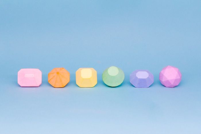 Six vibrant pieces of chalk, each shaped like a different gemstone.