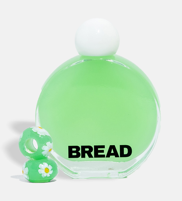 A close-up of the green serum oil and matching green sunflower beads.