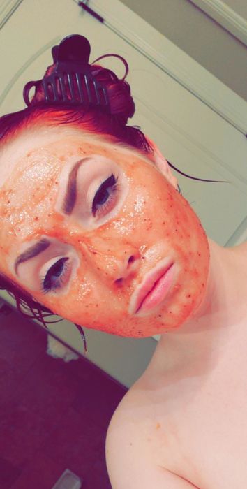 A reviewer sporting the pink strawberry mask.