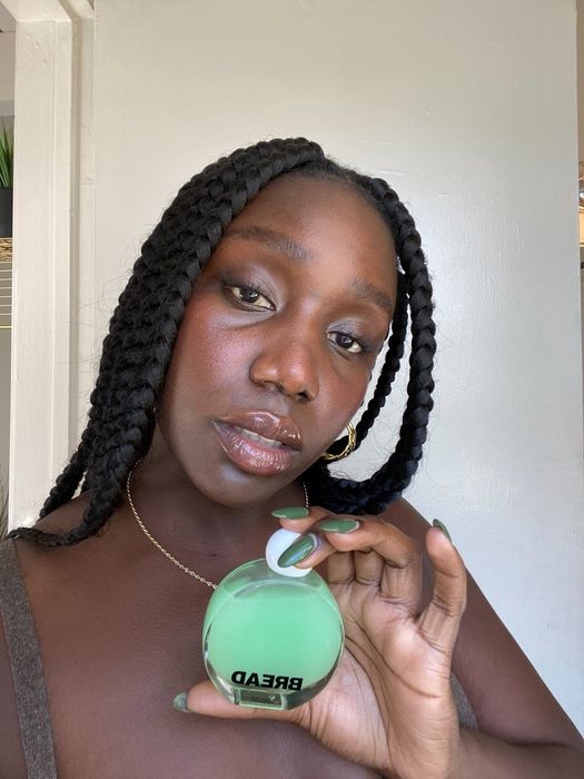A model holding a bottle of the serum oil.