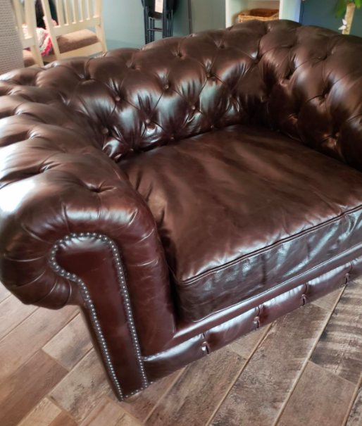 A reviewer's after photo showing a restored and vibrant brown leather armchair, now looking fresh and polished.