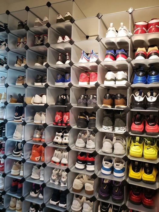 A closet packed with neatly stacked cubes, each one holding a different pair of shoes