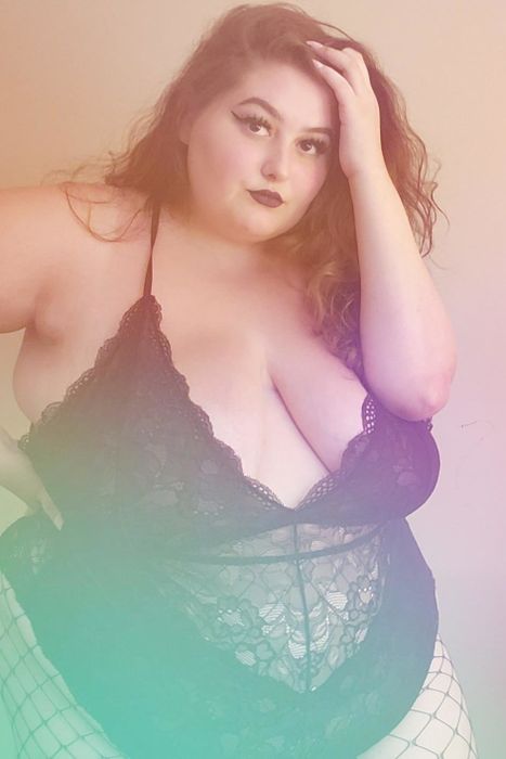 A reviewer donned in a sleek black bodysuit.