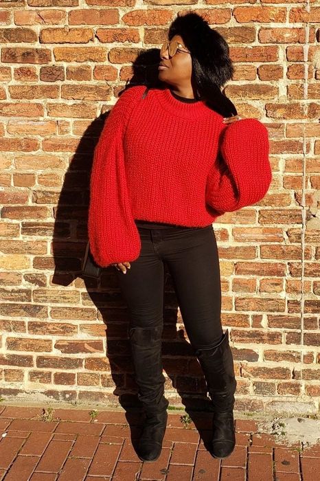 A customer review photo of them wearing the red sweater