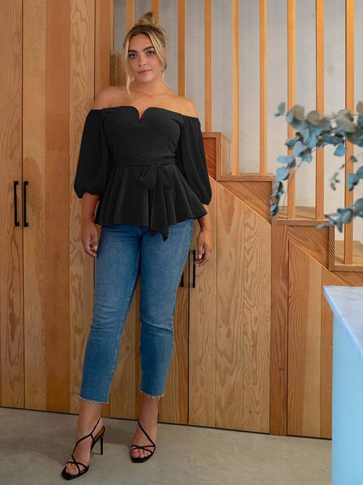 The model wearing a sleek black top.