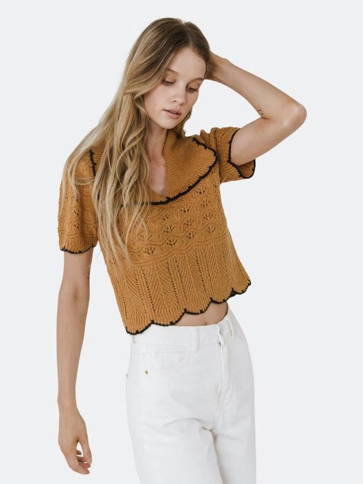 A model showcasing the Short Puff Sleeve Scalloped Knit Top in camel