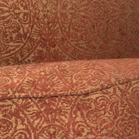 The same cushion after using the vacuum, now spotless and noticeably more vibrant