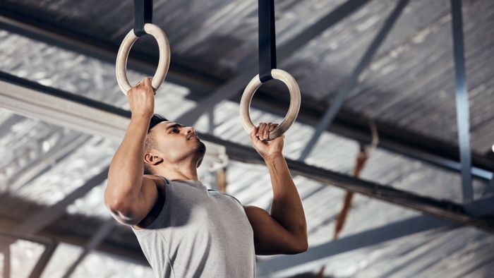 A person performing exercises on gymnastics rings