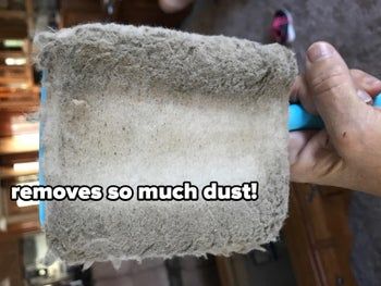 A reviewer's baseboard cleaning tool, its cloth covered with dust.