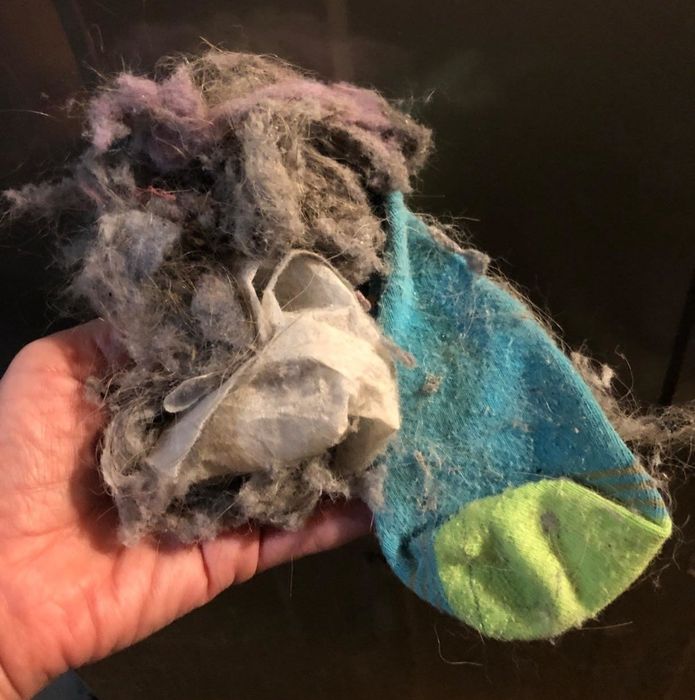 A reviewer's photo showing socks and lint pulled out of the dryer with the vent cleaner.