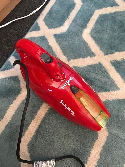 A red handheld Dirt Devil vacuum.