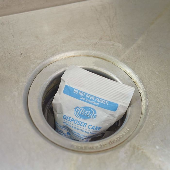 A cleaning packet placed inside a sink drain.