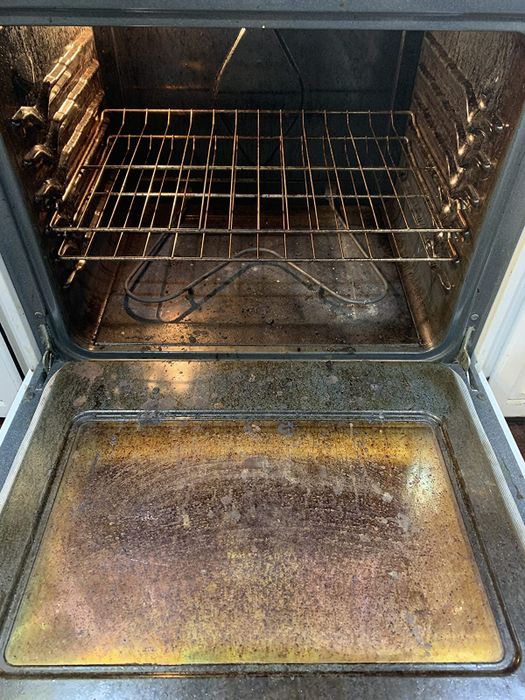 A reviewer photo showing the inside of a dirty, crusty oven before using the cleaner.