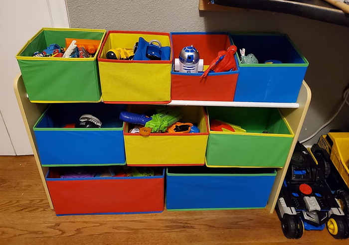 A reviewer’s photo showing the nine-bin storage unit, each bin filled with toys, offering a neat and organized solution for keeping play areas in check.