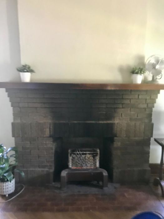 A customer review showing a fireplace mantel covered in soot before cleaning.
