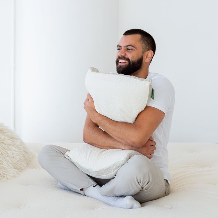 A model embracing the Avocado molded latex pillow