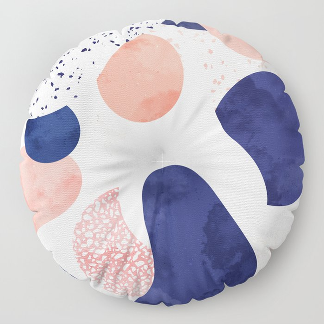 An abstract round pillow showcasing a variety of geometric shapes and patterns