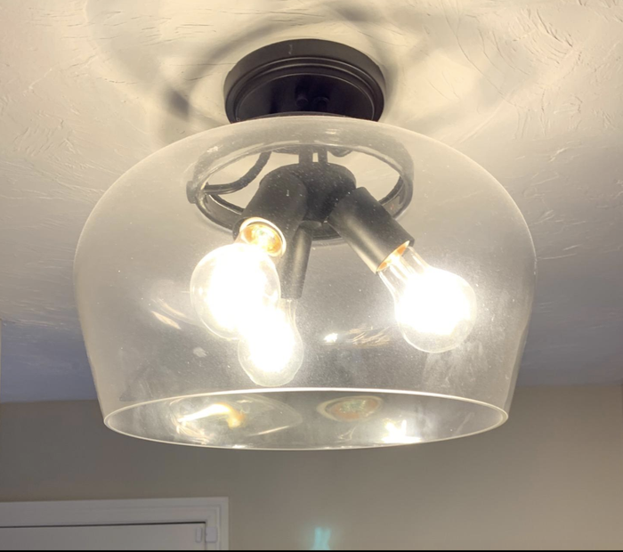 Reviewers note a glass light fixture in need of cleaning, looking dirty and neglected.