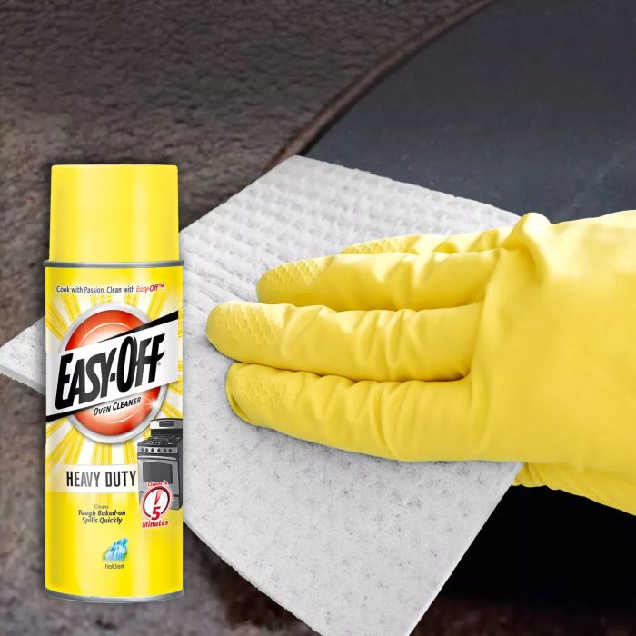 A bottle of grease remover placed over an image of a hand scrubbing grease.