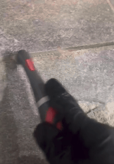 A GIF showing a reviewer cleaning grout with the product