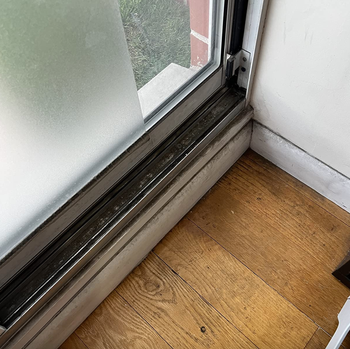 A review showing a windowsill covered in dirt and dust