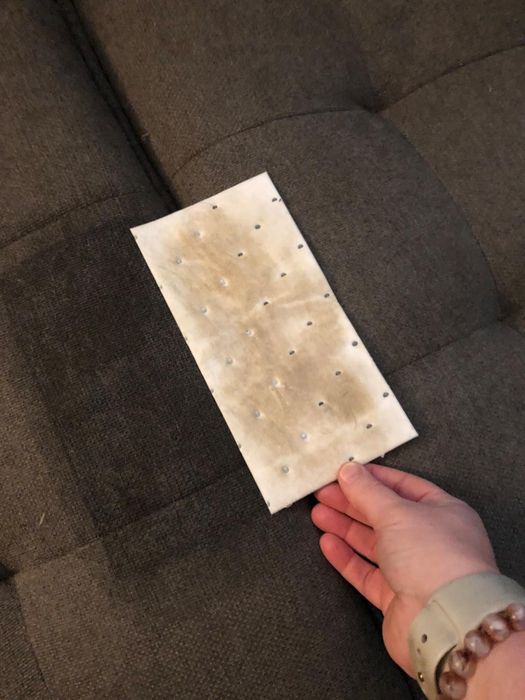 A reviewer holding a pad visibly stained after use