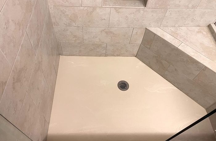 An after photo of the same shower floor, now completely spotless and clean.