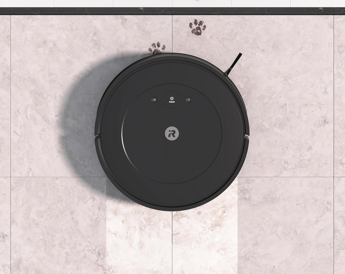 An iRobot Roomba vacuum mopping the floor.