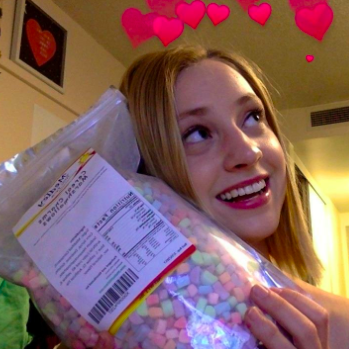 A reviewer proudly displaying the bag, with hearts floating above their head