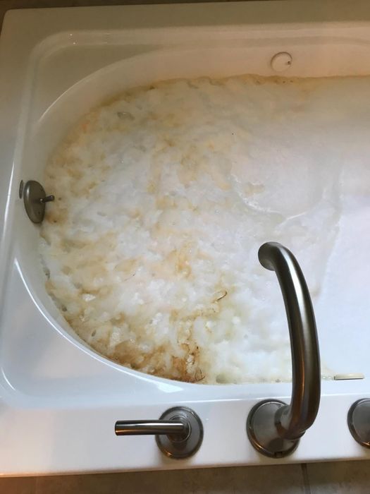 A reviewer’s photo showing dirt and debris being removed from their tub jets.