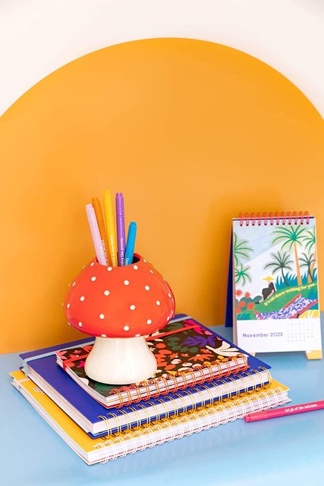 A red cap mushroom jar filled with pencils inside