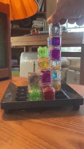 A video clip showing the marble journeying through a maze of stacked cubes as it falls into place.