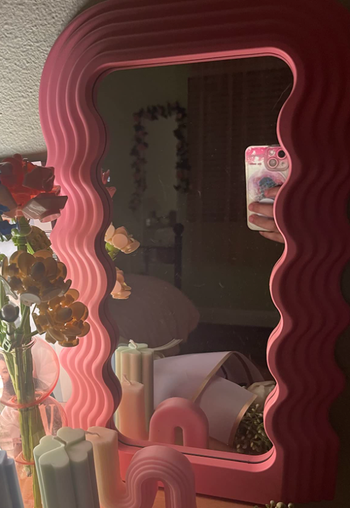 A reviewer's mirror on a bedroom vanity