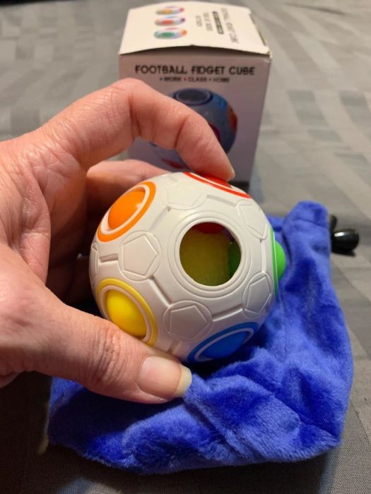 A reviewer's photo of them playing with the fidget ball