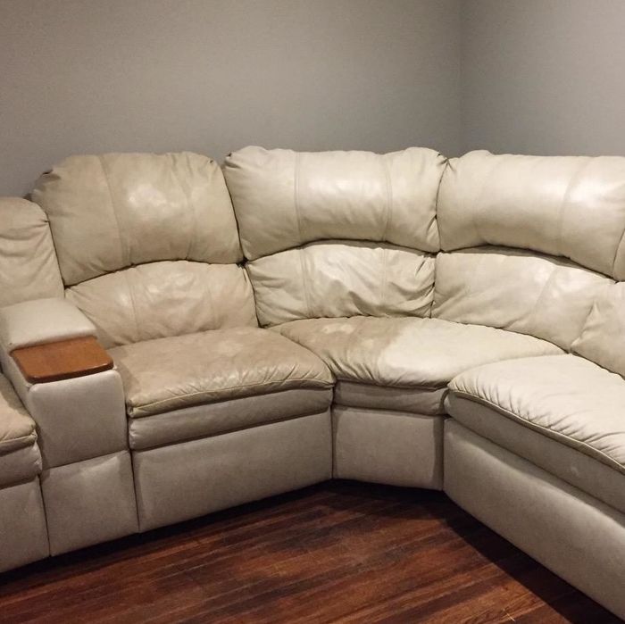 A reviewer demonstrates the effect of the cleaner on white leather chairs, with one side showing darker, slightly brownish discoloration, and the other side visibly brighter and cleaner after use.