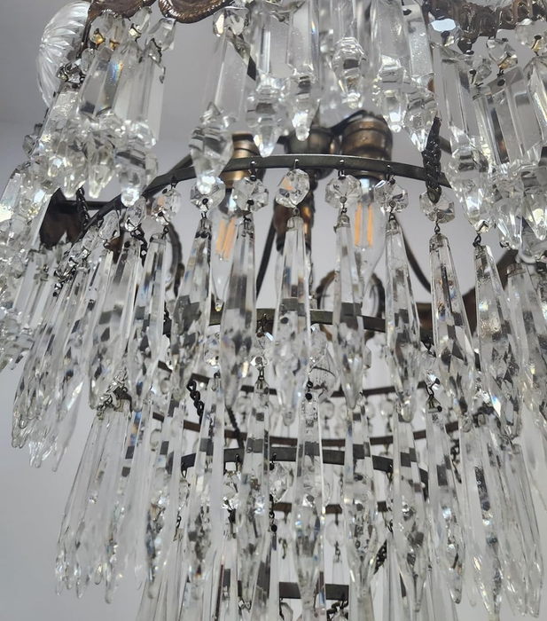 A close-up of the same chandelier now sparkling clean.