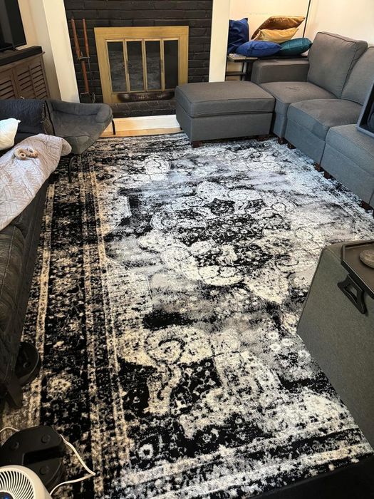 A black and white rug after being cleaned, with no trace of stains left.