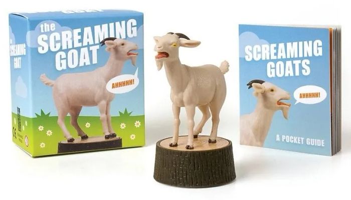 The goat figurine, its packaging, and the included booklet