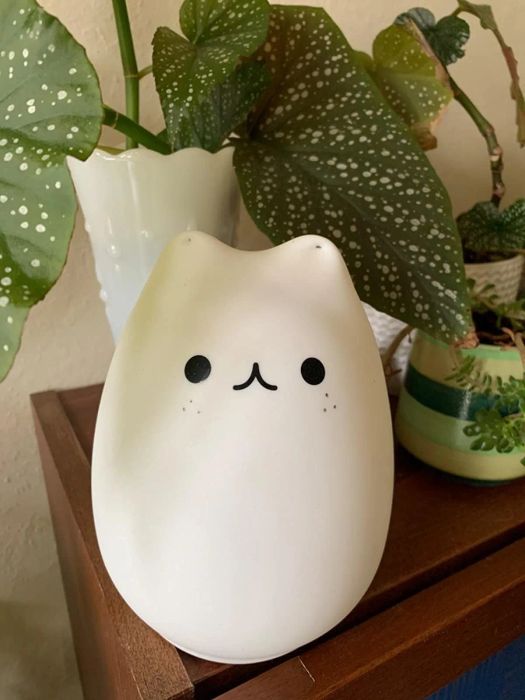 A reviewer photo of a cat-shaped lamp resting on a table