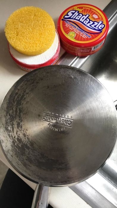 a stainless steel skillet partially cleaned and partially soiled