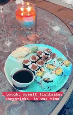 Mytour Editor Emma Lord uses blue lightsaber chopsticks to pick up a piece of sushi