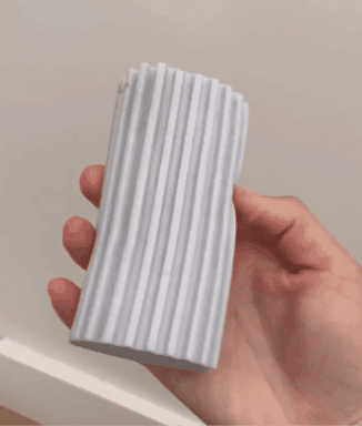 GIF showing a reviewer using the sponge duster to effortlessly clean baseboards.