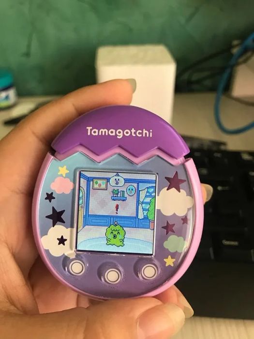 A review photo showcasing the Tamagotchi Pix in a cute pink color