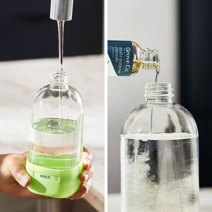 a person fills the bottle with a mix of cleaning solution concentrate and water