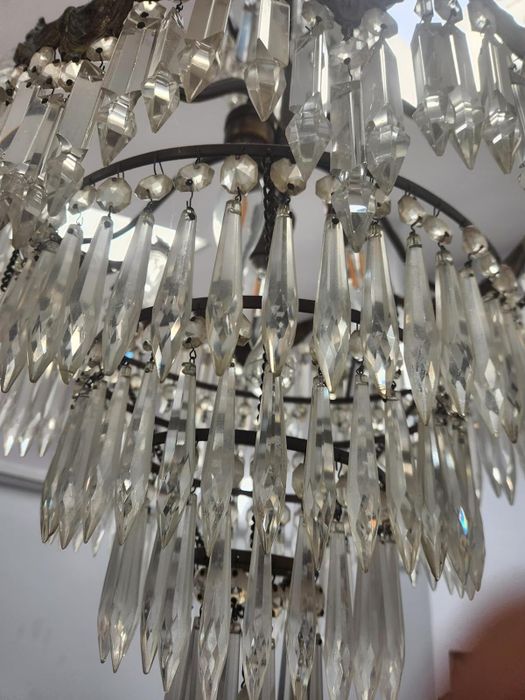 A close-up of a dirty crystal chandelier.